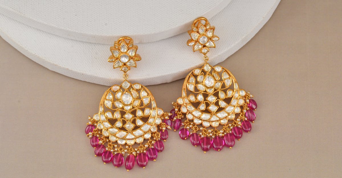 Luxurious gold earrings adorned with diamonds and rubies, perfect for elegant occasions.